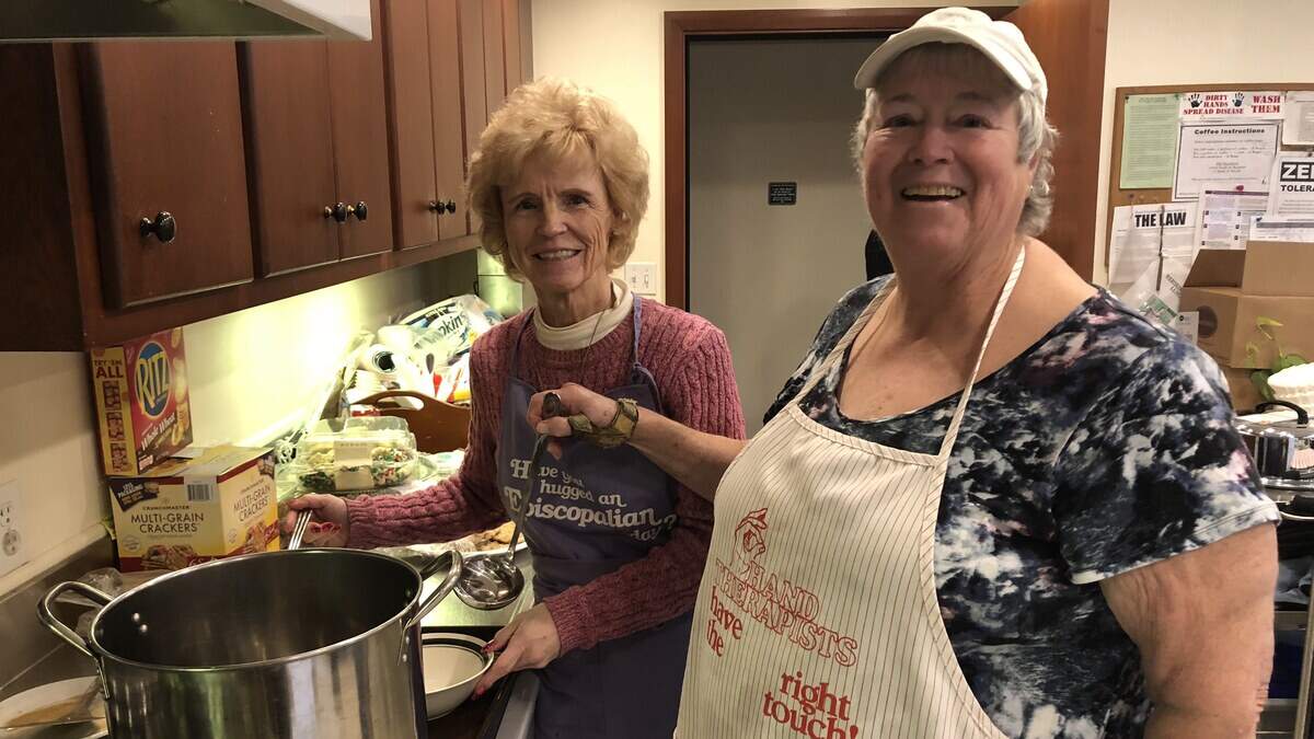 Linda Potter (left) and Kathy Mason help behind the scenes at Christ Episcopal Church of Puyallup for the weekly soup luncheon, which serves meals to those in need. Dec. 12, 2018