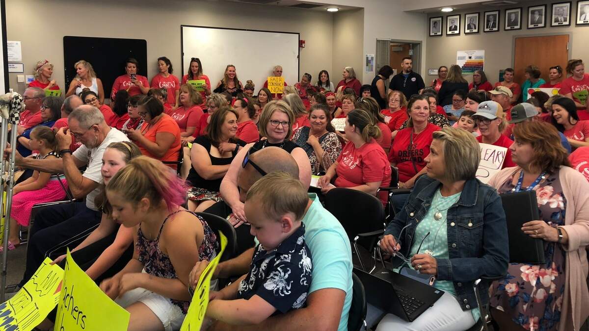 Sumner Education Association teachers, bus drivers and food service employees crowd the Sumner School District board meeting on Aug. 15 to speak to the school board about increased wages.