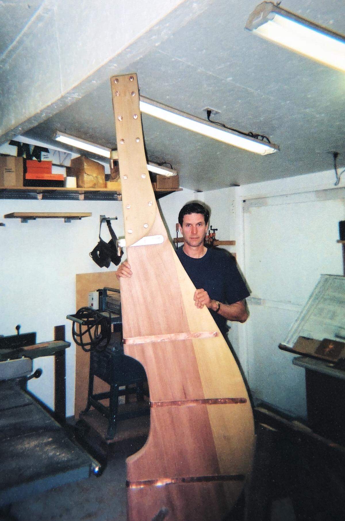 Tom Crout with the rudder of his sailboat in 2002, two years after he started building the craft at his South Hill home near Puyallup.