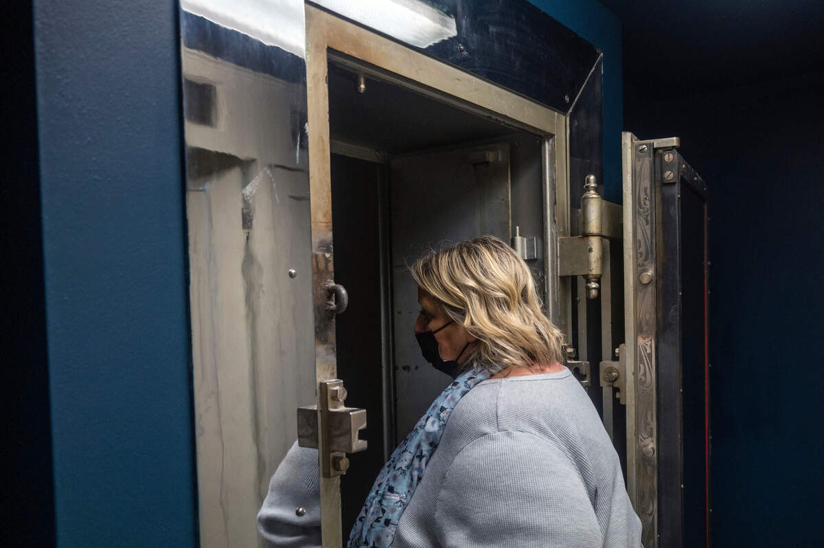 Jan Martinell walks into one of two former vaults inside the new Enumclaw game store, Cole Street Game Vault, on Friday evening. Martinell and her husband, Chad, purchased the former bank building in downtown Enumclaw and turned it into a store that sells all sorts of board games, strategy games and card games.