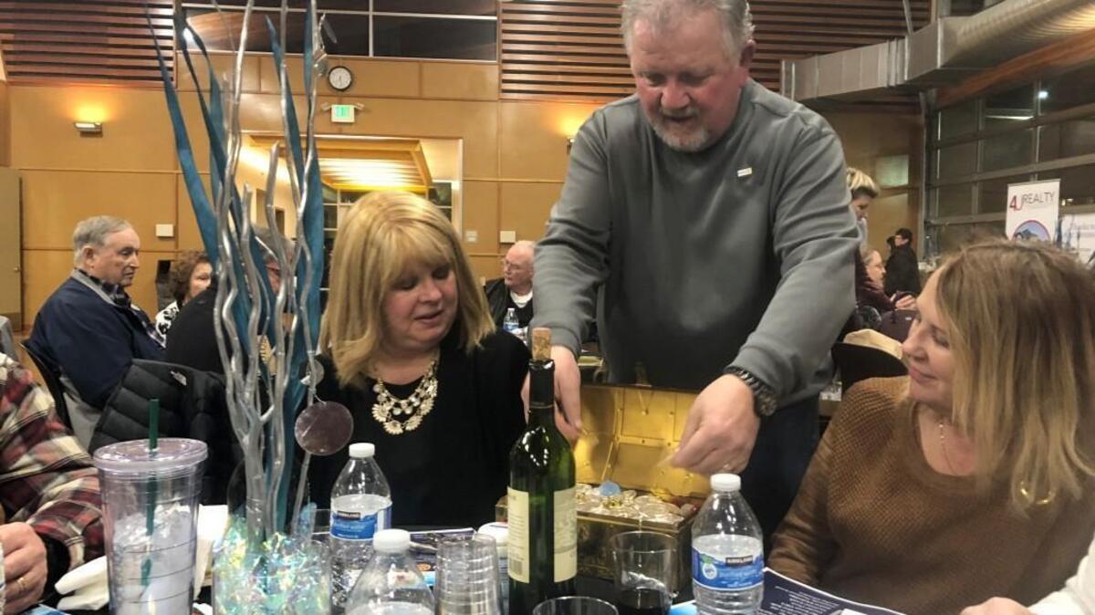 Puyallup-South Hill Rotary past president Jeff Lieurance shows off $9,000 in bullion at the Gold and Silver Reverse Raffle on Feb. 22.