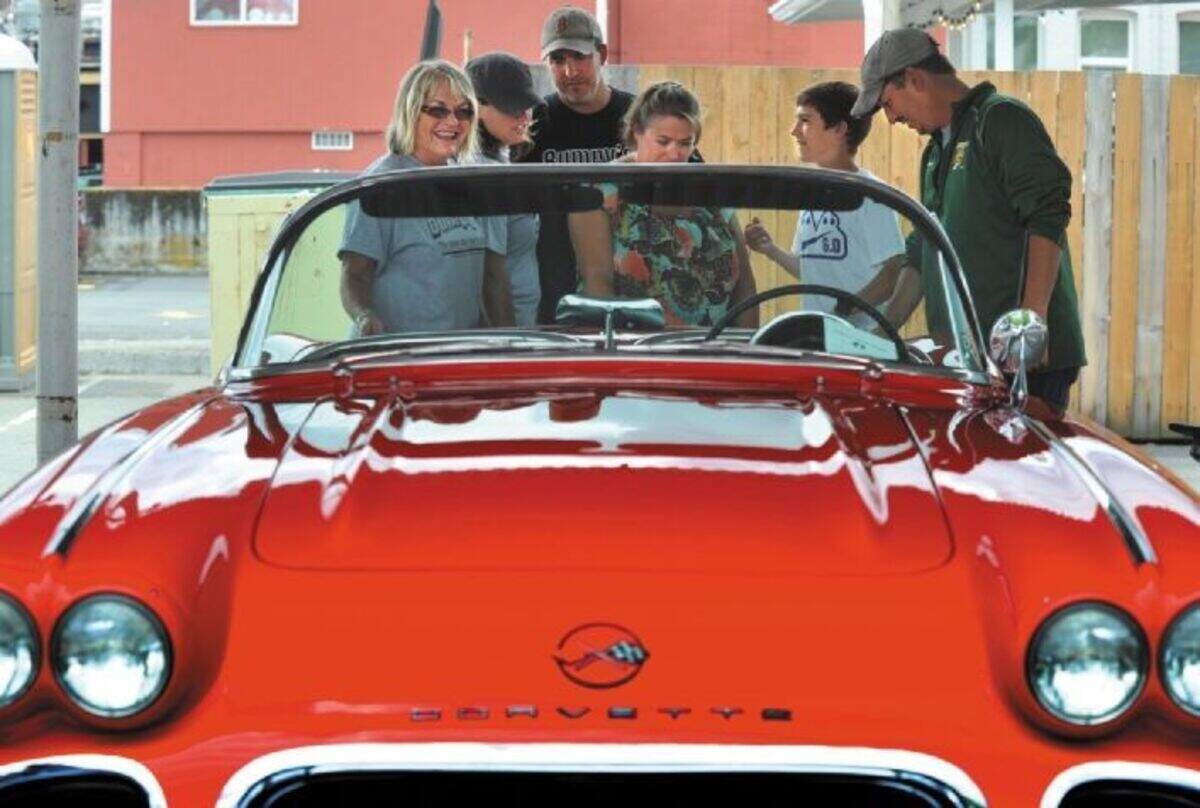 Family of Paul Gaetz gather behind Paul Gaetz’s 1962 Chevrolet Corvette that was given to grandson Blake Nelson at the Bumpy’s Classic Car Show on Saturday, July 16, 2011 in Puyallup. 