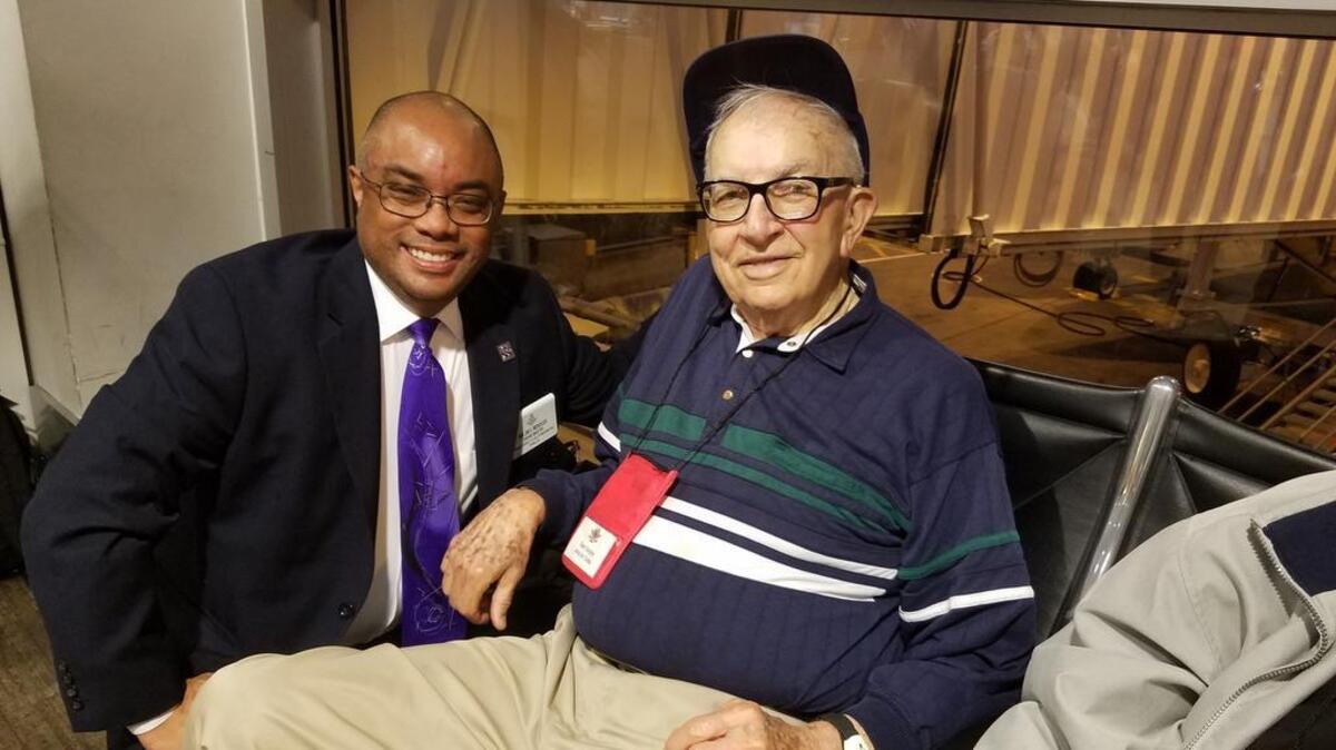 Jim Mendoza, left, with one of the veterans he met at an Honor Flight arrival.