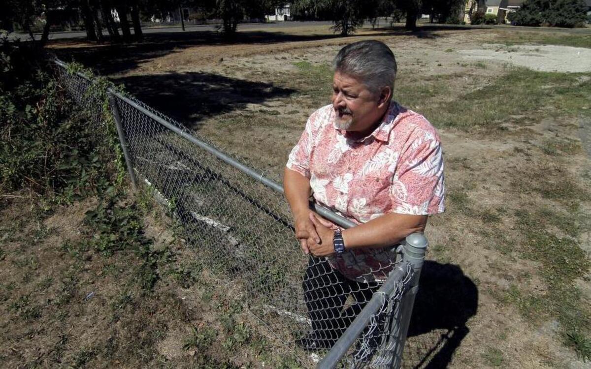 
Puyallup School District athletic director Rick Wells looks over vacant lots next to Sparks Stadium last week. The district is hoping to extend the stadium’s footprint with the addition of practice fields to the west border of the facility. 
