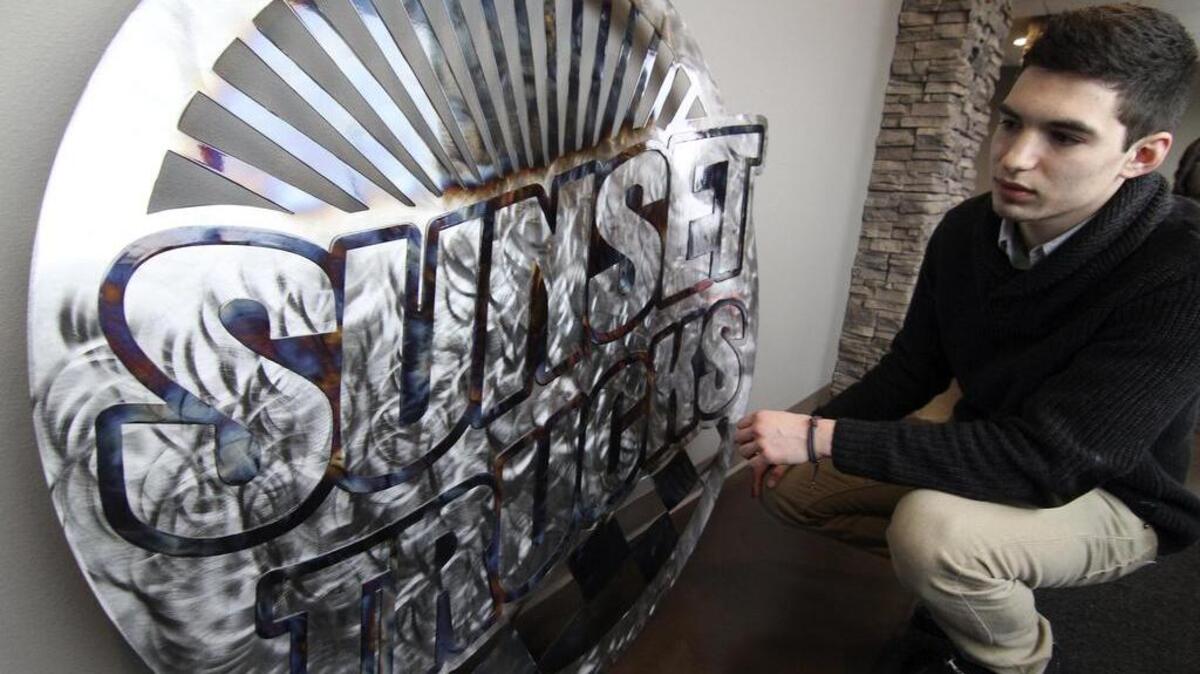 Man Cave Metal Works owner Josh Buffington looks over new steel-crafted sign he made for Sunset Chevrolet Trucks along River Road in Puyallup last week. Buffington, 20, was named Entrepreneur of the Year at the Puyallup/Sumner Chamber’s Rising Star banquet on Jan. 13.