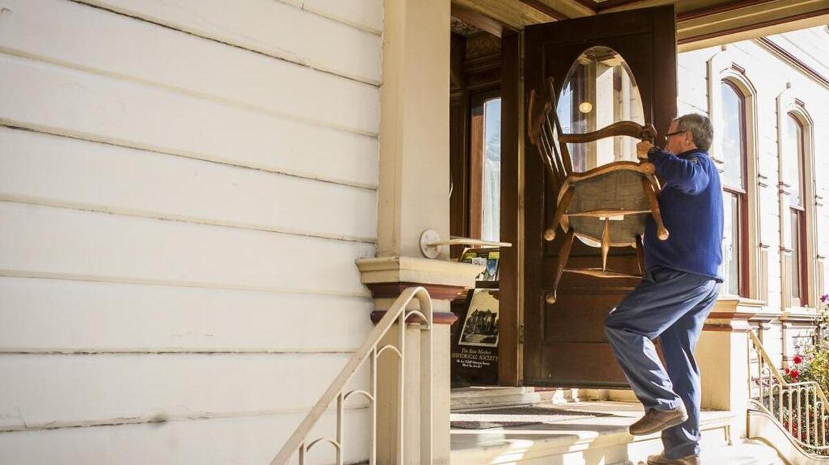 Bruce Cadwell, great-great-grandson of Ezra Meeker, reunites a dining room chair with the Meeker Mansion on Oct. 10.