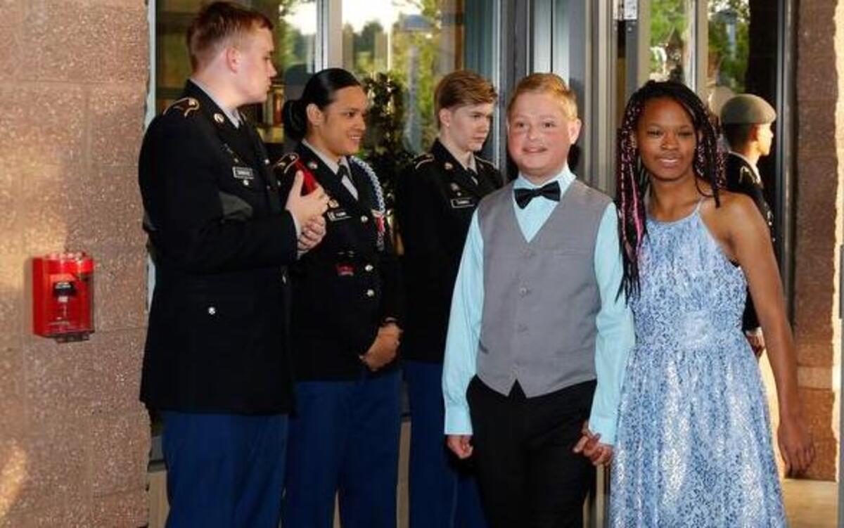 Emerald Ridge High School sweethearts Joey Miller and Mikayla Fernandez, a Special Olympics basketball player, make their entrance to the Unified Prom on Saturday night at the high school. More than 100 students from area high schools attended.