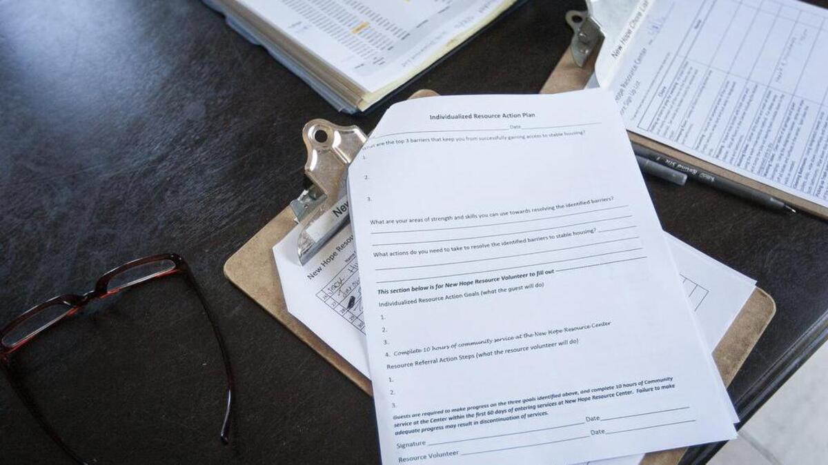 Paperwork sits on the table at New Hope Resource Center in Puyallup on Friday. The paperwork, which includes an action plan, code of conduct and information sheets, is a new addition to the center.