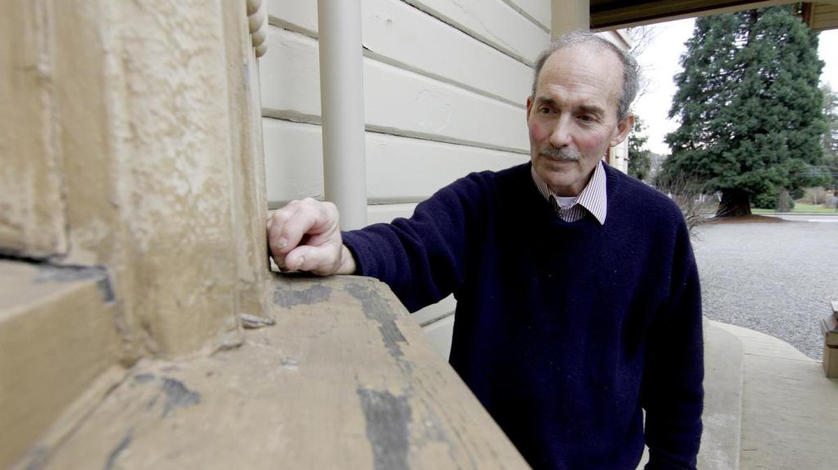 Bob Minnich, president of the Puyallup Historical Society at Meeker Mansion, looks over some of the cracked and peeling paint of the mansion. Minnich, who passed away on June 14 at the age of 66, had a long history with the Puyallup Historical Society, and became president in the early 1990s.