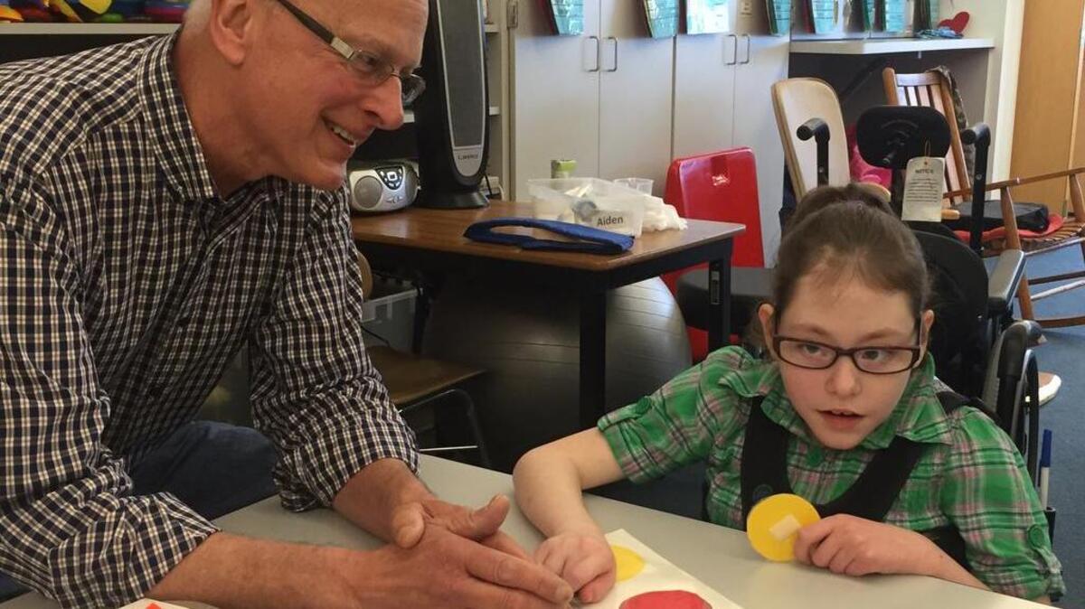 Don Jackson was recently named Primary Teacher of the Year for the Puyallup School District. The longtime teacher of 21 years works with student Calla Schulz last week in his classroom at Brouillet Elementary School.