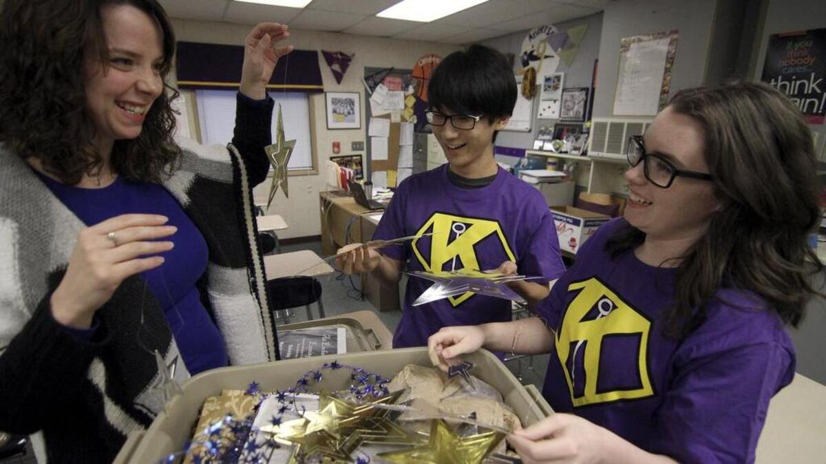 Puyallup High School math teacher and Key Club advisor Jessica Anderson, left, looks over Starry Night senior dance decorations with students and Key Club members Abraham Lee and Morigan Hooper last week at the school. The annual dance features a Jazz band, decorations and refreshments for Puyallup area seniors during the event at the high school.