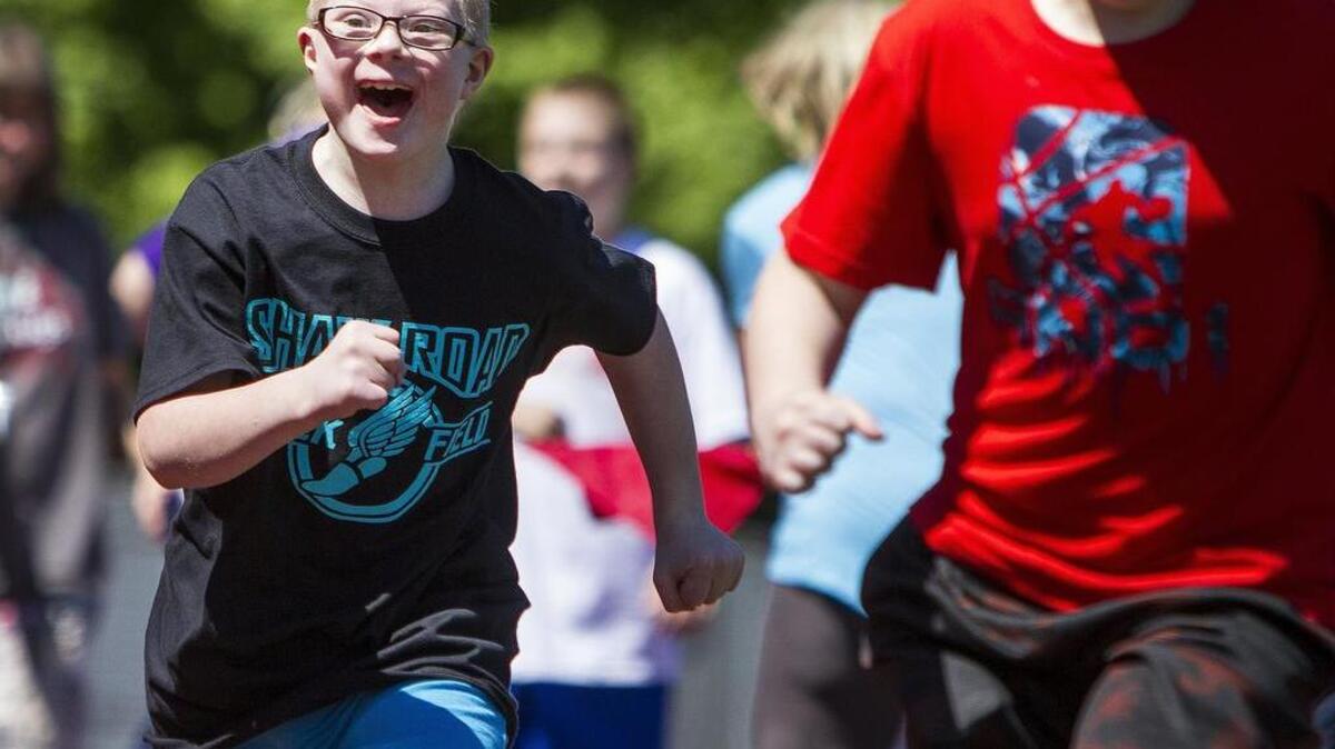Joshua Olels, left, races down the track in the 50-meter race during the Special Spring Track Meet at Sparks Stadium on Friday.