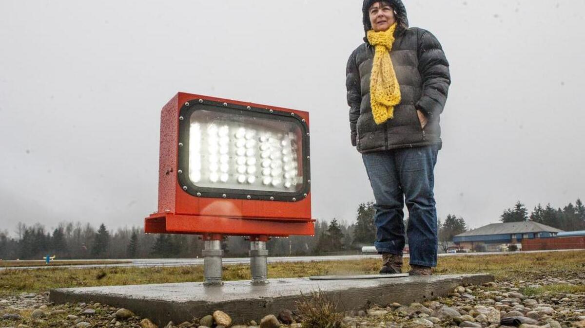 Thun Field maintenance lead Lissa Smith stands next to one of the new guiding lights installed along the Thun Field runway in on South Hill earlier this year. Pierce County is embarking on an 18-month journey to update its master plan for the airport, which hasn’t been updated since 1999.
