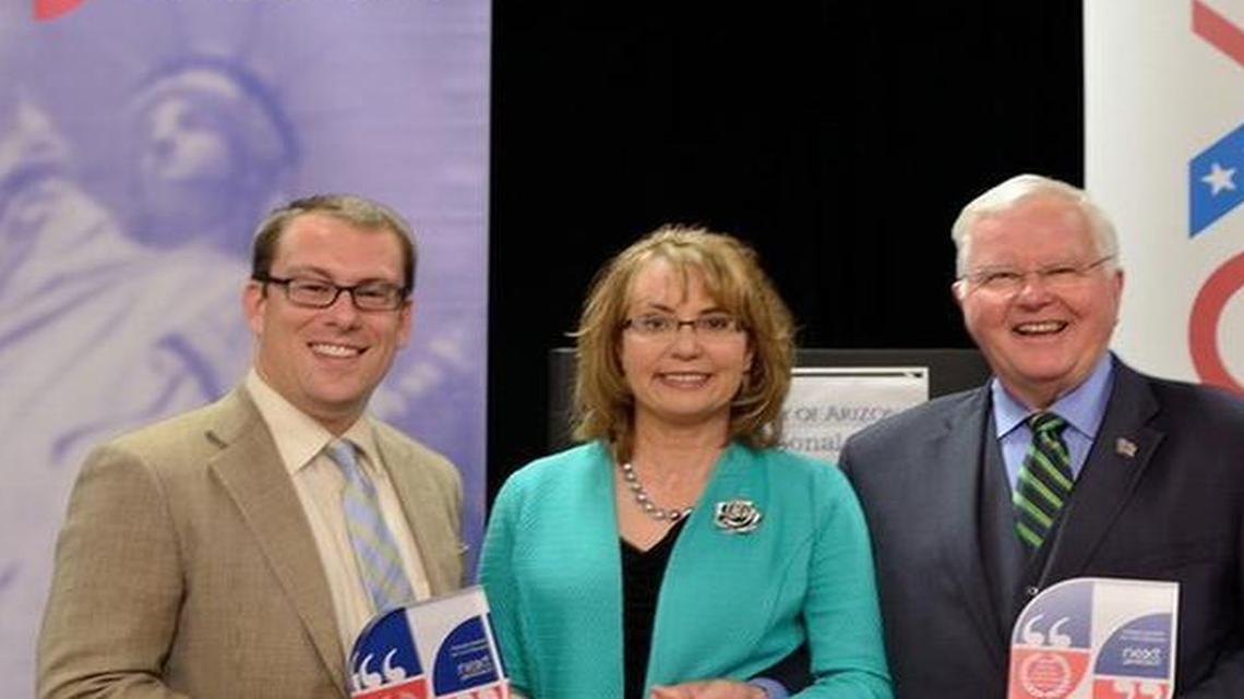 
Gabrielle Giffords, along with her husband Mark Kelly, far right, present the award for Civility in State Government to state House Reps. Hans Zeiger, left, and Sam Hunt, center.

