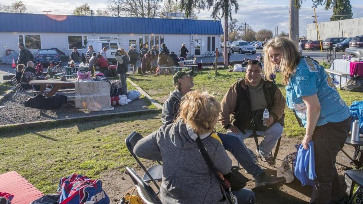 Homeless folks wait outside the newly-closed New Hope Resource Center in downtown Puyallup last week.