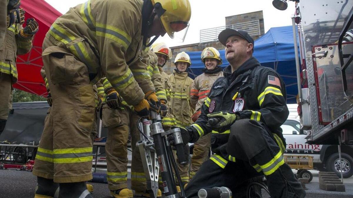 Puyallup extrication team trainer Mark Schmidt, right, leads a class for new firefighters outside the new Central Pierce Fire & Rescue training tower. The tower — part of a two-year renovation of the fire district’s headquarters — simulates fire situations in kitchens, bedrooms and living rooms, in addition to roof and technical rescues.