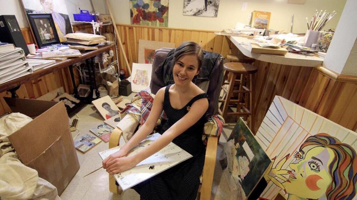 Artist Anna Laura Kastama is surrounded by some of her works in her Puyallup home-based art studio. The 23-year-old native recently finished showing her paintings of former Daffodil Festival Queens in an exhibition at Puyallup City Hall.