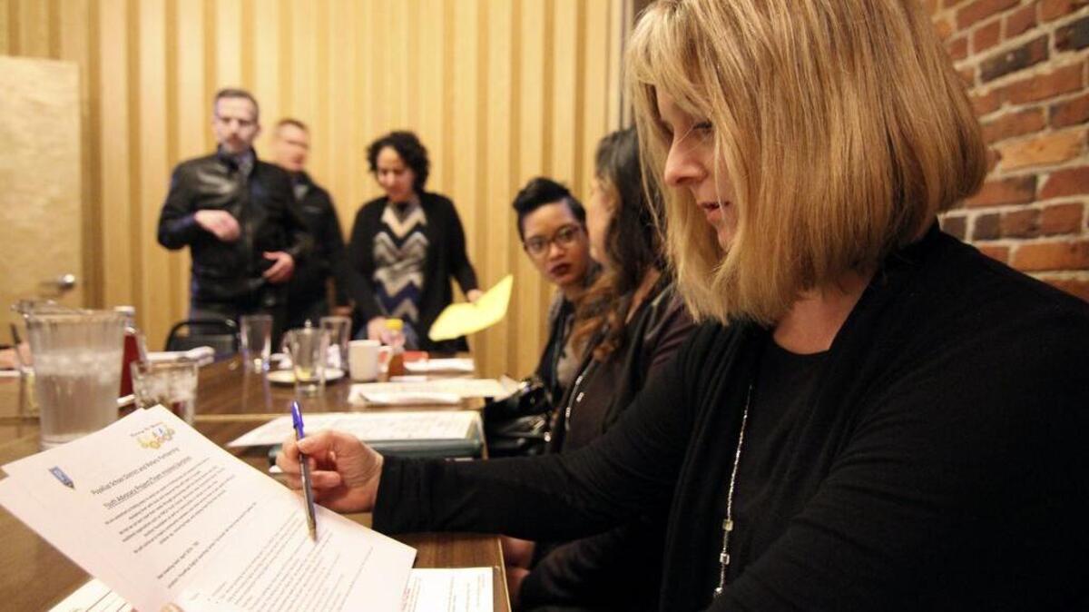 Puyallup High School Vice Principal Maija Thiel looks over the agenda during a Youth Advocacy Project Team meeting last week in Puyallup.