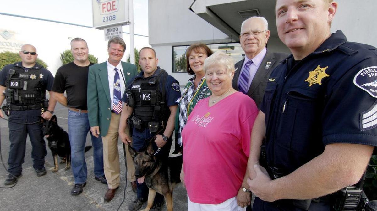 Members of the Puyallup-based Eagles Daffodil Aerie 2308 and Pierce County Sheriffs Department deputies and K-9 officers pose their their pups at the Eagles building before a demonstration for club members. The Aerie raised $2,500 toward the acquiring and training of a new K-9 officer, “Doc,” the 2-year-old partner to human counterpart Theron Hardesty.