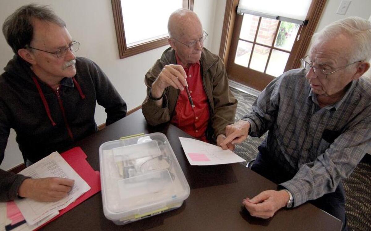 South Hill Historical Society treasurer Ben Peters, left, past president Paul Hackett and Carl Vest, director of research, talk during a meeting last week in Puyallup.
