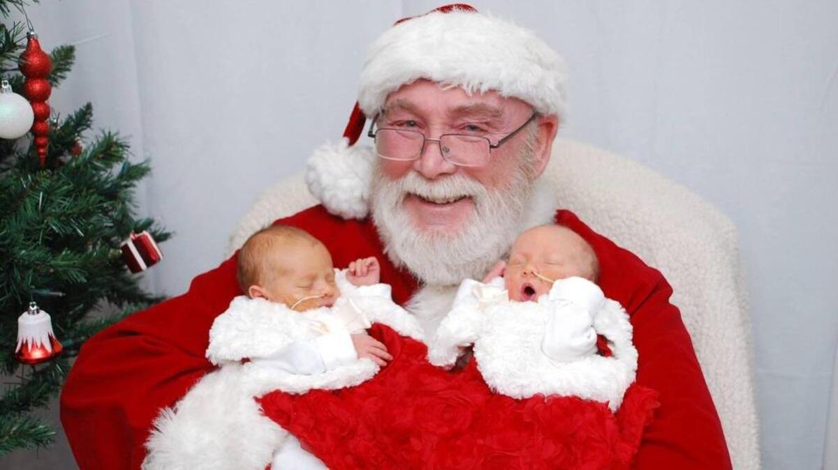 Newborn twins Paisley and Harper get their picture taken with Santa at Good Samaritan Hospital in Puyallup. Their mother, Jaymi, experienced the loss of pregnancies with twins twice before the sisters were born.