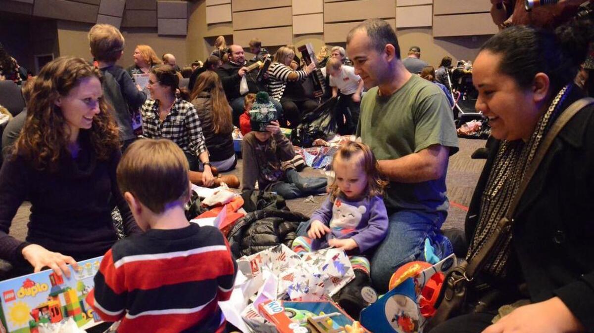 Foster and adopted children and their parents open gifts after a party hosted especially for them Saturday at a South Hill church to celebrate Christmas and meet their favorite Star Wars characters. The party, held at Bethany Baptist Church, was sponsored by Youth for Christ’s Foster Program, with hundreds of hours of volunteer labor donated by members of Puyallup’s Whitewater Church.