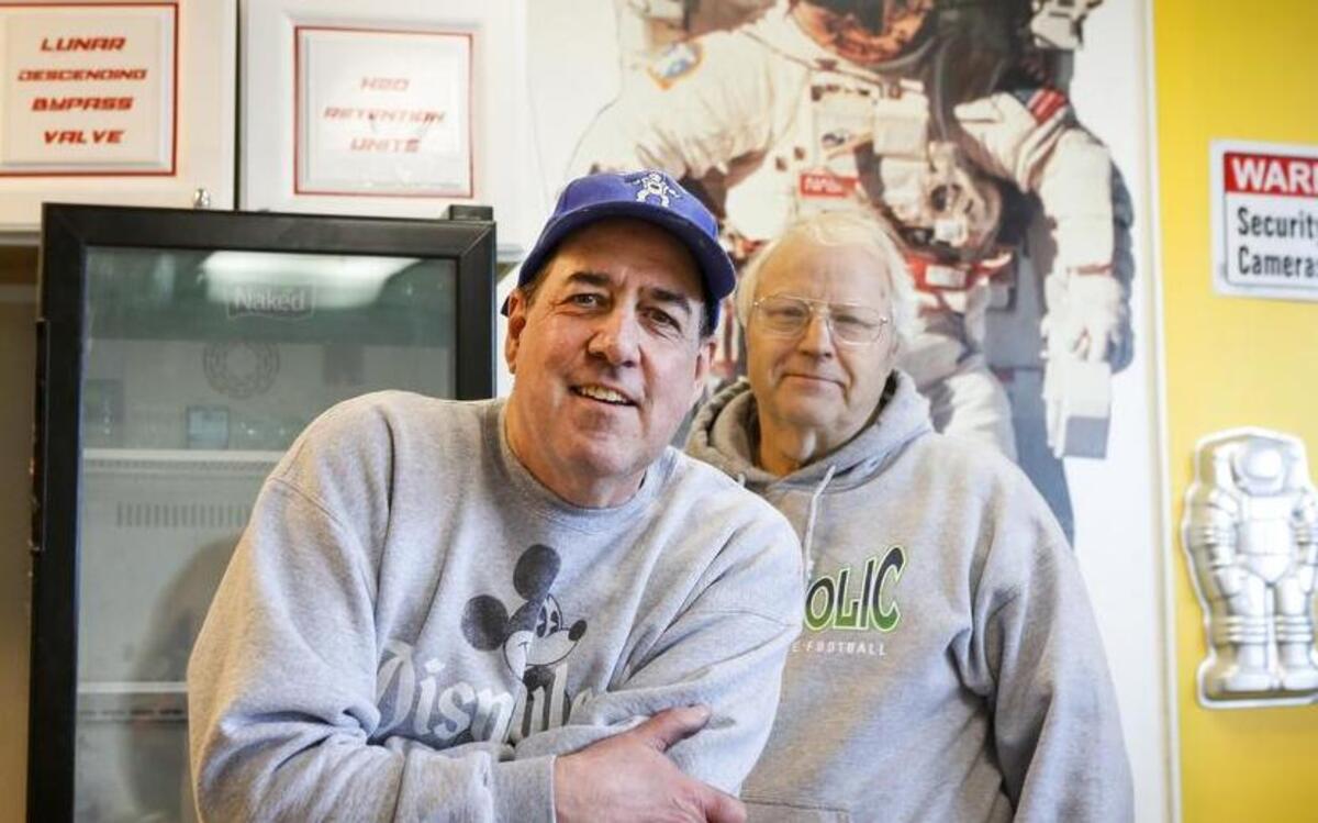 Tom Dobrinski, left, stands for a portrait with friend Charles Cox at Epic Donuts on South Hill. Dobrinski decided to close the shop earlier this month, but a buyer stepped in late last week to keep it open.