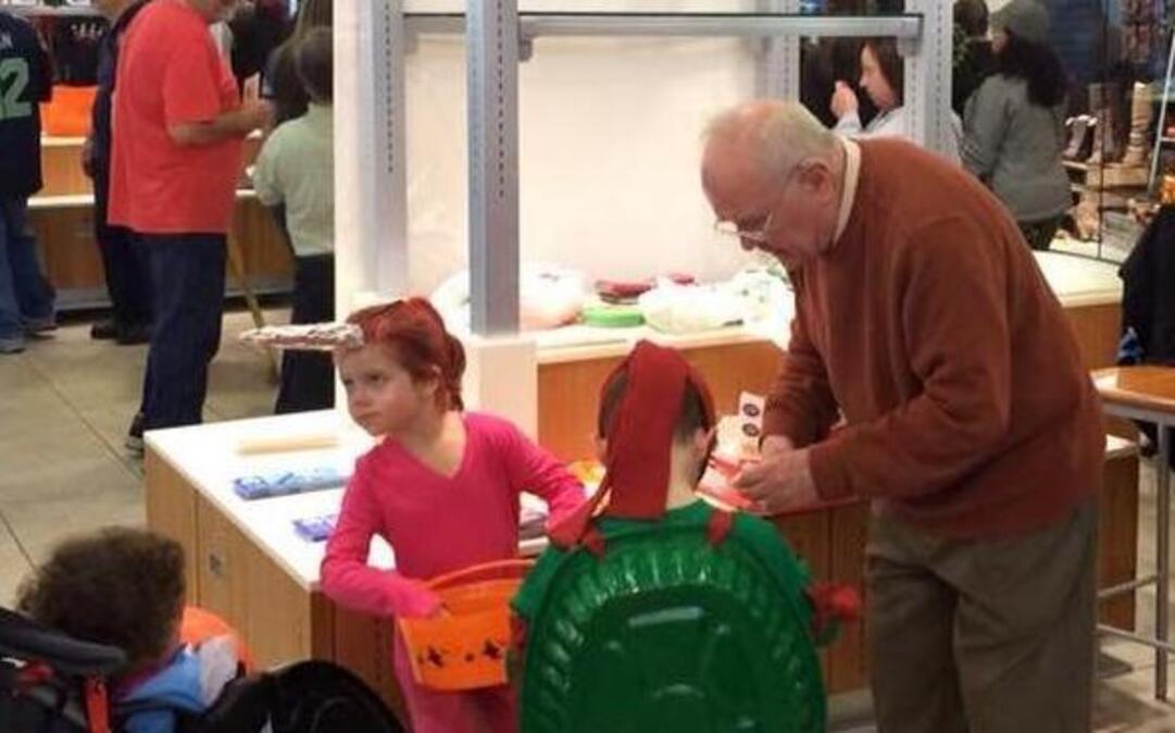 Masonic Lodge member John Adamson hands out candy on Halloween at the South Hill Mall as part of the Service Clubs of Puyallup’s outreach event.