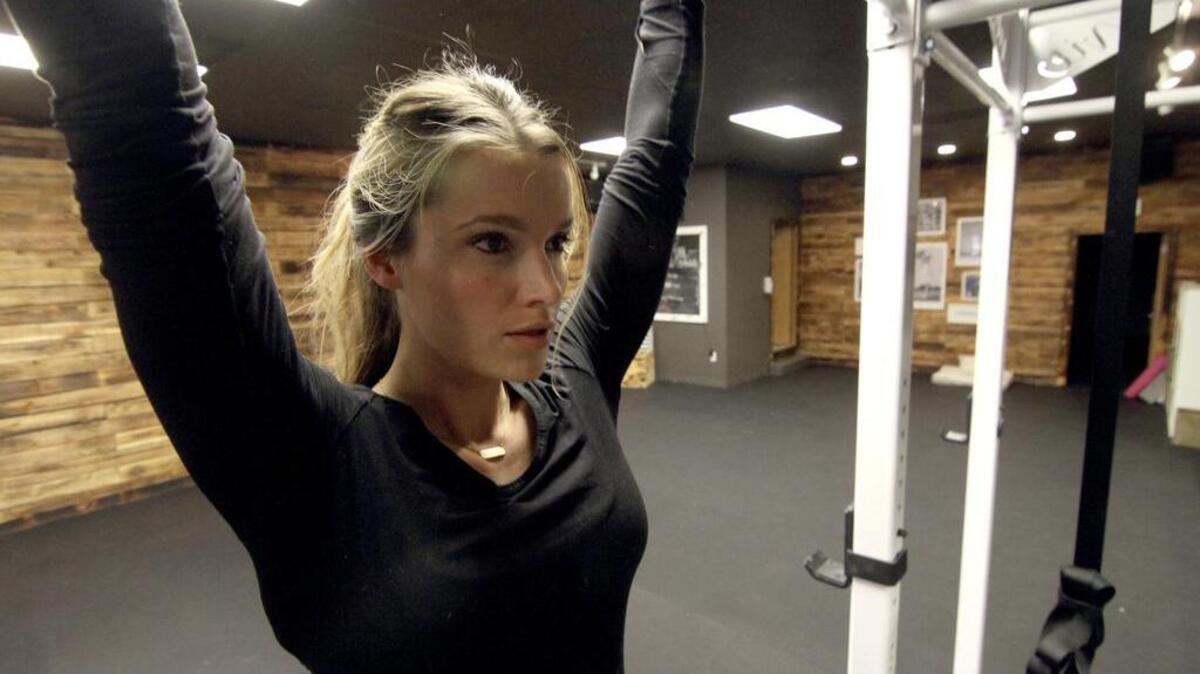 Vie Athletics owner Amber French does pull-ups at the new women-only Puyallup gym last week.