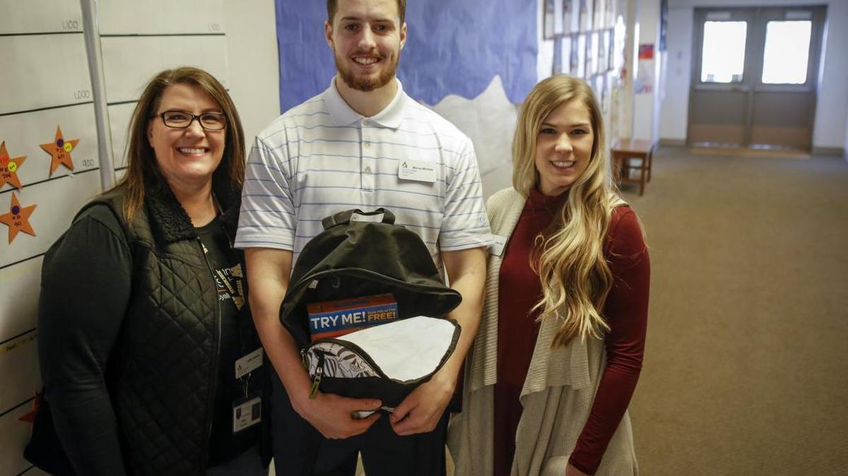 Julie Curran, Marcus Micheles and Colleen Davis, from left, with Communities in Schools, stand for a portrait at Firgrove Elementary in Puyallup. Communities in Schools has a Weekend Backpack Program that delivers backpacks full of food to Puyallup School District students.