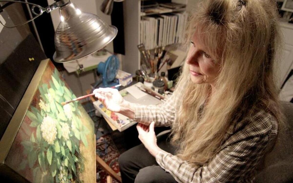 
Puyallup artist Linda Jacobus paints in her South Hill home last week. Jacobus recently won a first-place ribbon for one of her works in a contest at the Washington State Fair.
