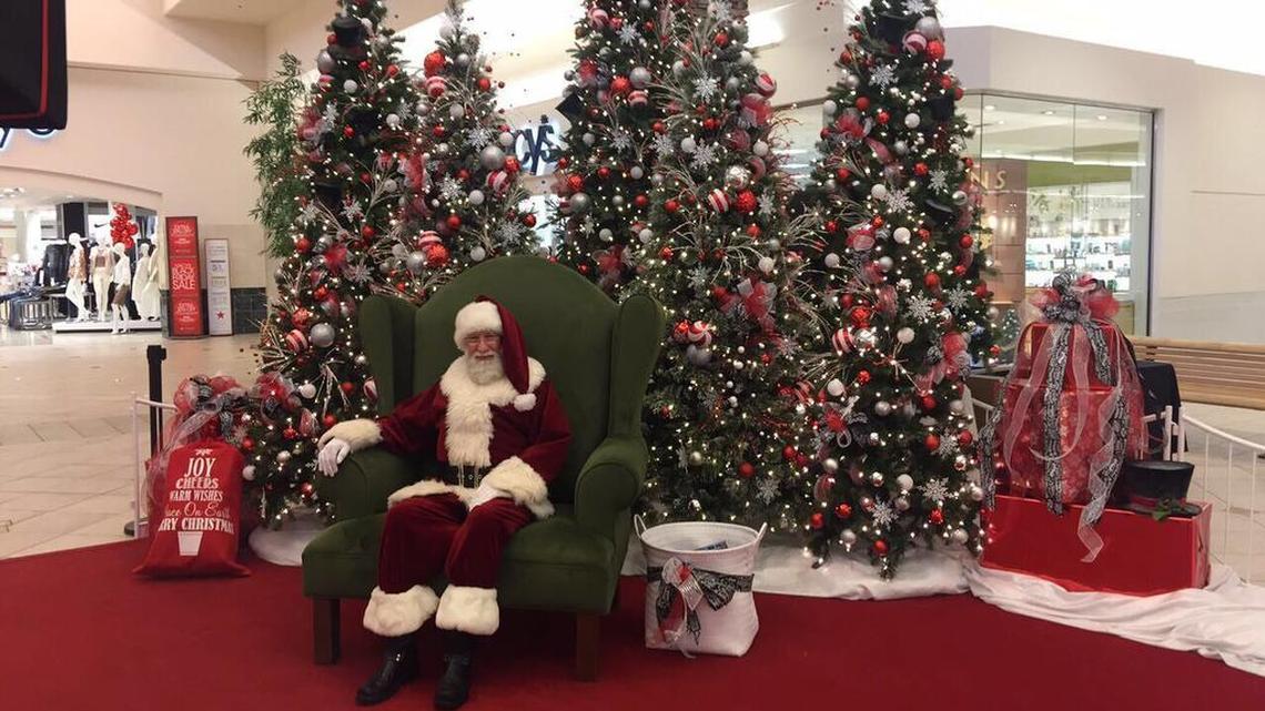 South Hill Mall’s Santa sits in front of his picture display. Aside from his chair, which was damaged from a fire and professionally restored, the rest of the decorations had to be purchased retail.