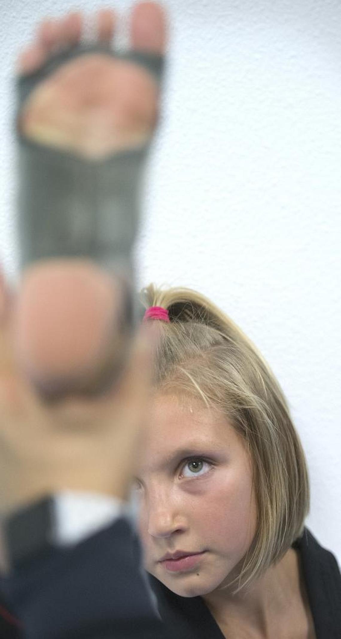 Zoee Martinson stretches during training at Twin Tigers Taekwondo martial arts school in Tacoma on Wednesday, Sept. 6. The 10-year-old black belt from Puyallup won two gold medals and a championship title at the Northern California Taekwondo Games in August.