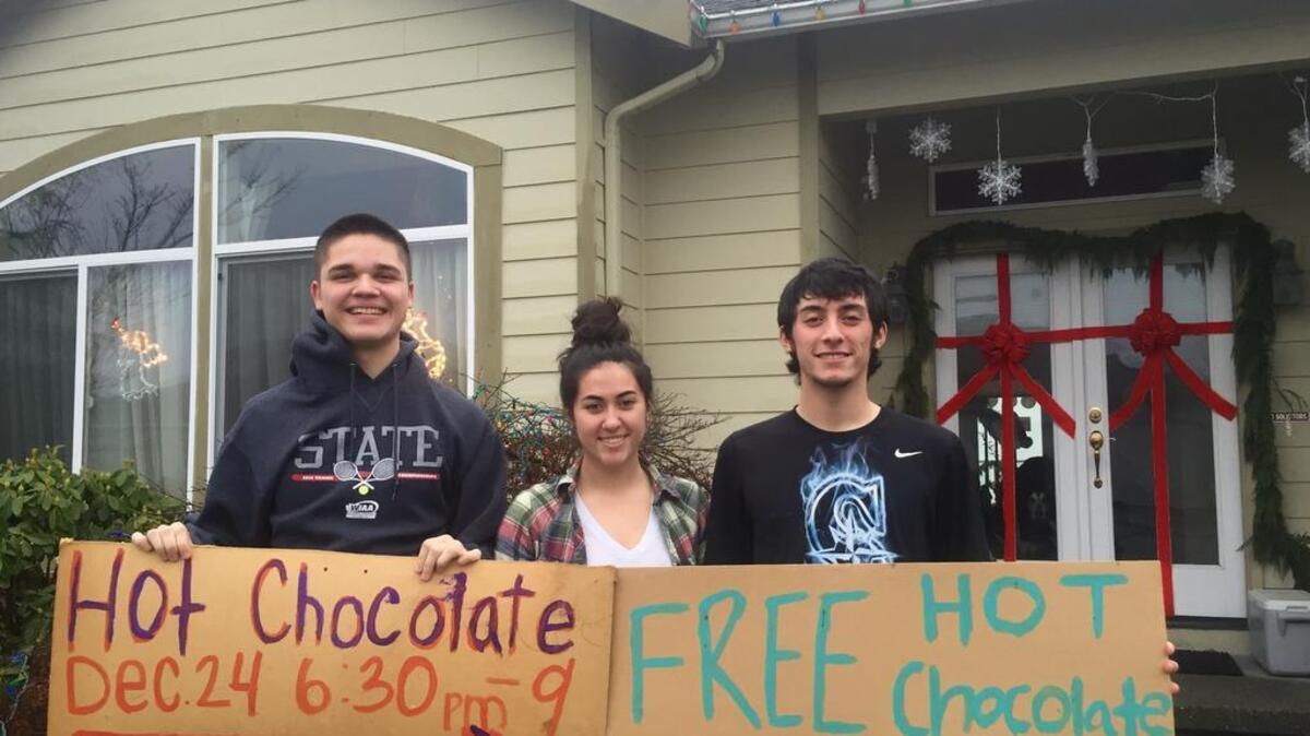Zakary Landers and siblings Samantha and Brandon Walsh, from left, gather for a photo in the midst of preparing for the annual hot chocolate stand benefiting the Bonney Lake Food Bank.
