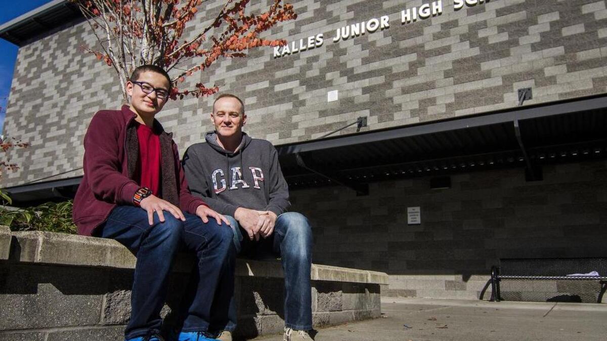 Fourteen-year-old William “Kent” Arnold, left, performed CPR on his father, Mike Arnold, in the parking lot of LA Fitness in South Hill on Aug. 29. His actions kept his father’s blood circulating during a heart attack, which helped to save his life. Kent learned CPR training in eighth grade in a health class at Kalles Junior High School in Puyallup.