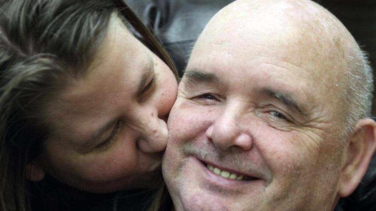 Douglas “Hop” Roush gets a kiss from his 12-year finance, LeeAnn Hollandworth, last week during the TBI support group meeting that had an early Valentine’s Day party for its members.