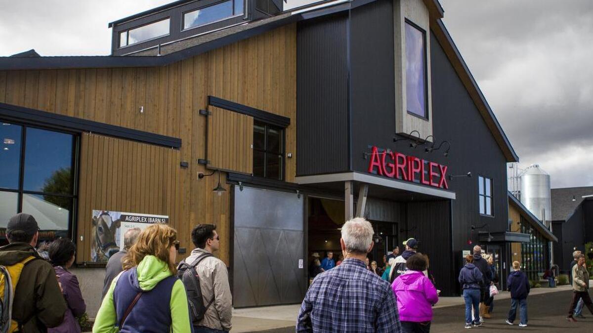 Fair attendees walk by the new Agriplex building at the Washington State Fair.