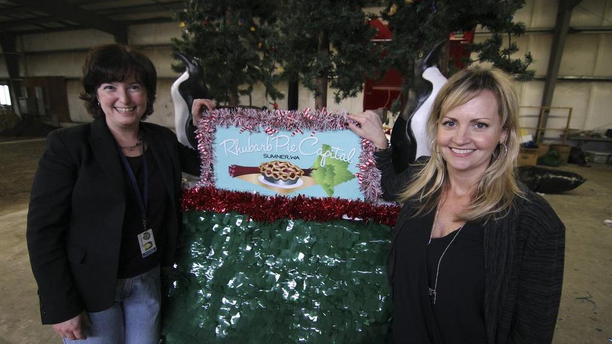 City of Sumner Communications Director Carmen Palmer, left, and event coordinator Lana Hoover pose with the city’s Santa Parade float. The float is being put together by dedicated volunteers at the old Sumner Meadows Golf Course.