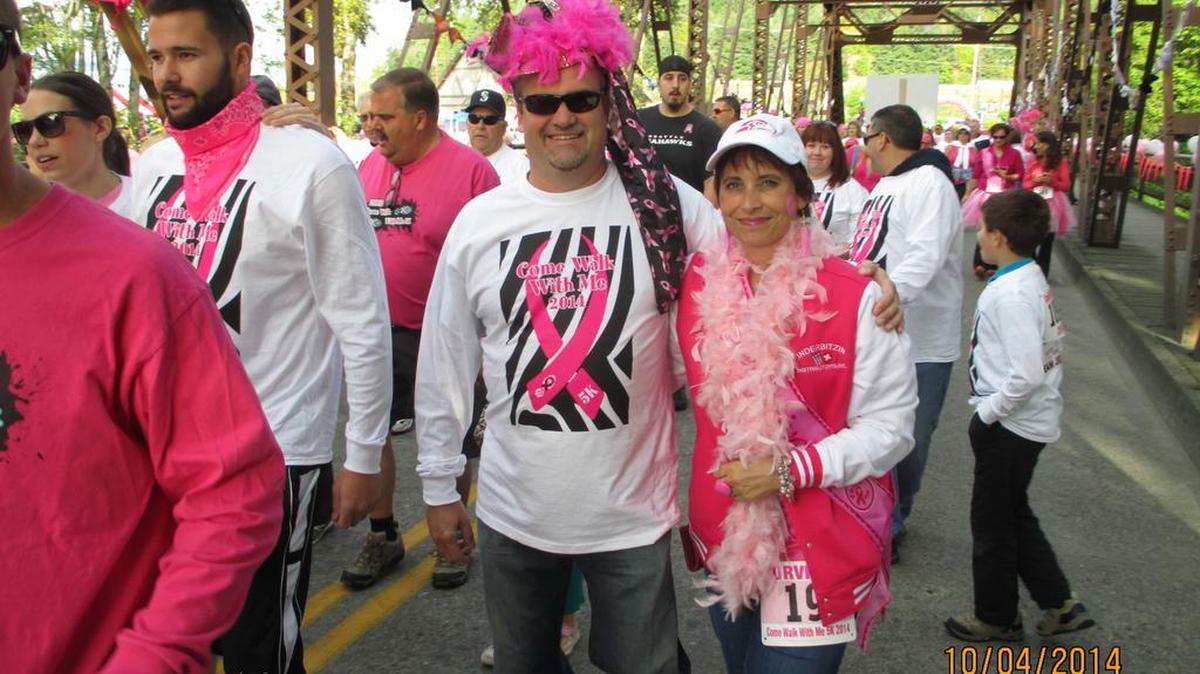 
Jenny Inderbitzin walks with her husband, John, during the Come Walk with Me 5K, a fundraising event for women undergoing breast cancer treatments. 

