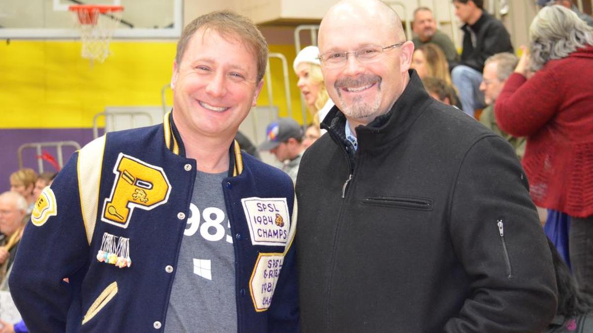 Mike Egan, Class of 1985, catches up with Dr. Tim Yeomans, Puyallup School District superintendent, during Puyallup High’s annual Alumni Assembly. Egan said he squeezed into his letterman jacket for the special event.