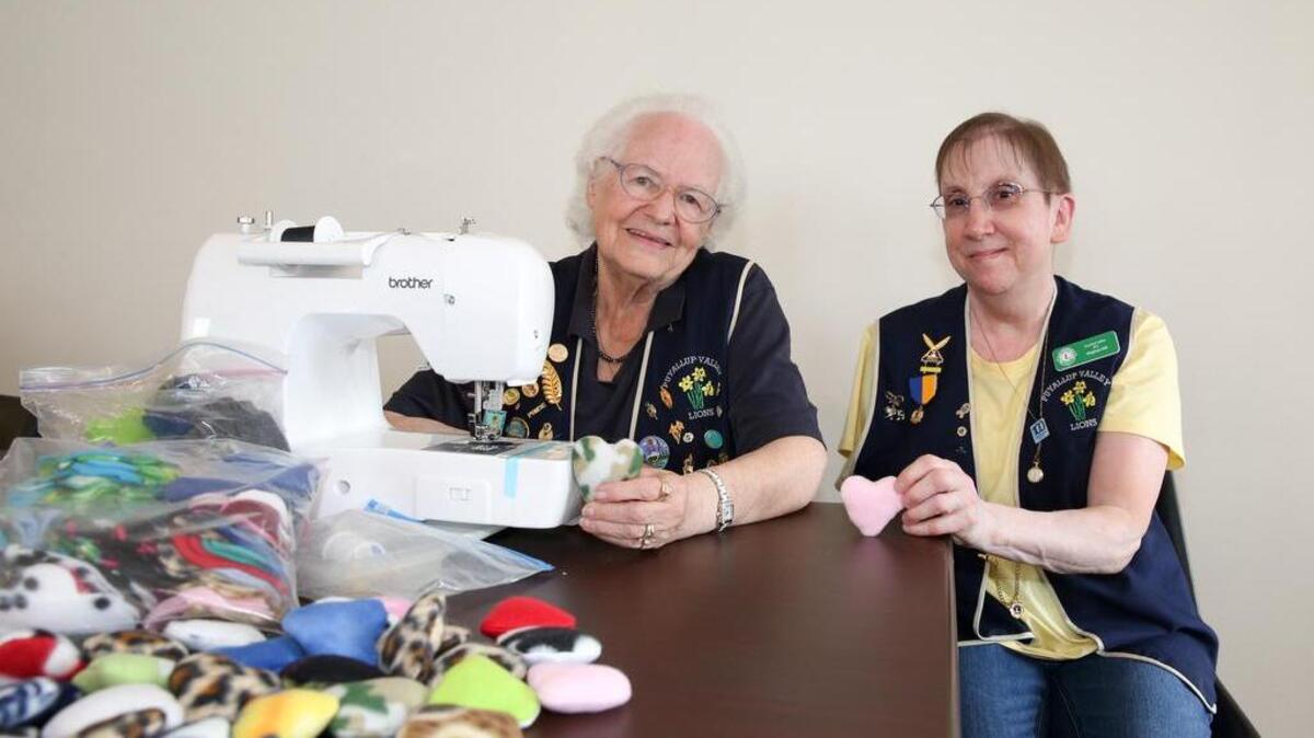Puyallup Valley Lions Club members Marilyn Fankhauser, left, and Virginia Hill show the little fabric hearts that the group make and hand out to siblings of children in the ER. Fankhauser has been a member of the Lions Club for more than 12 years.
