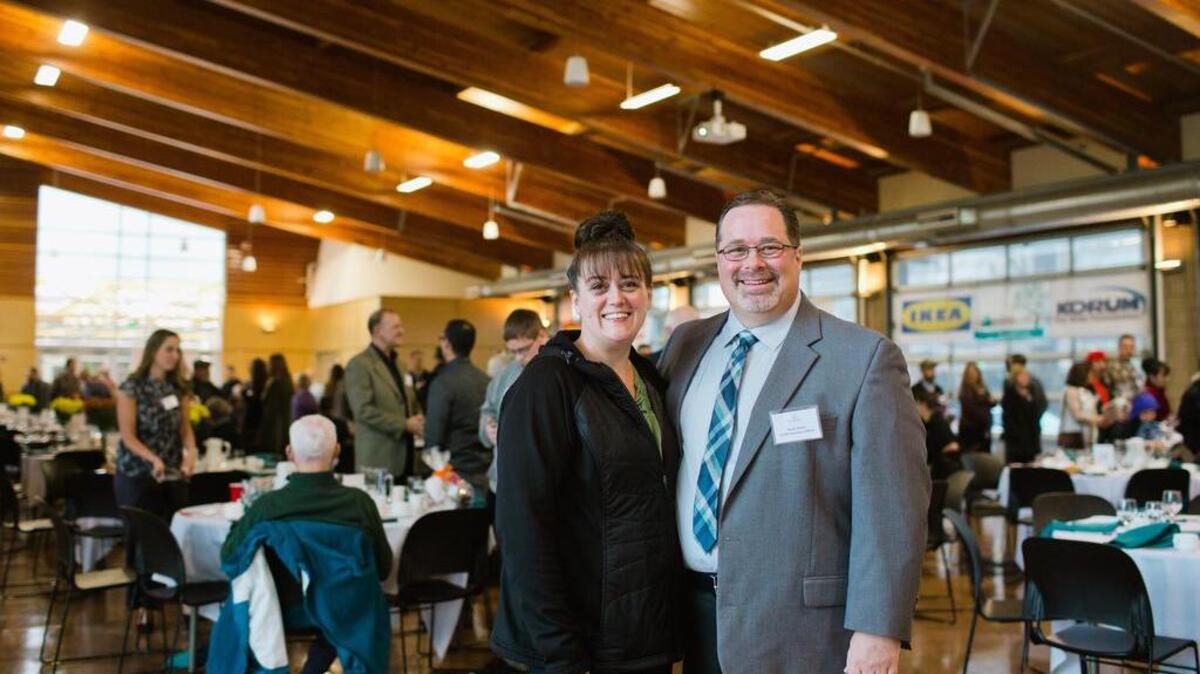 Helping Hand House executive director Kevin Bates and Bonnie Young stand together at the annual Helping Hand House breakfast. Young shared her story of how Helping Hand House helped get her back on her feet.