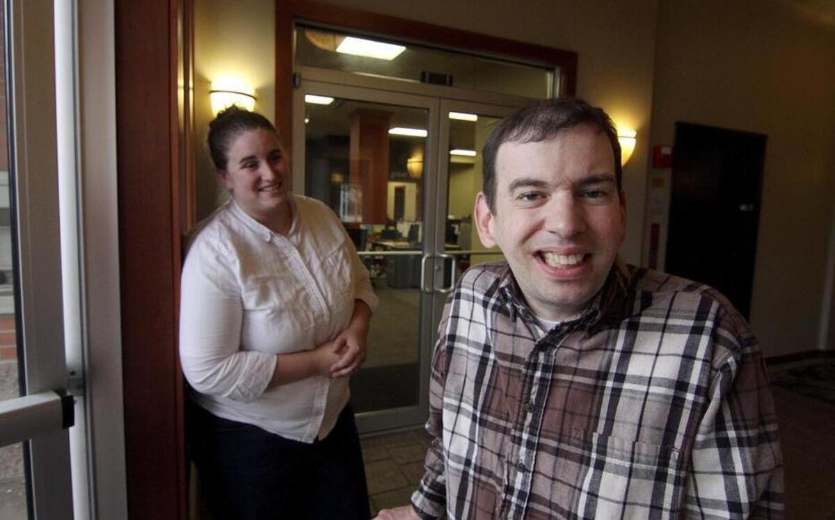 Trillium Employment Services client Daniel Bala leaves the nonprofit’s new building on Meridian last week after working with Annie Harris, left.
