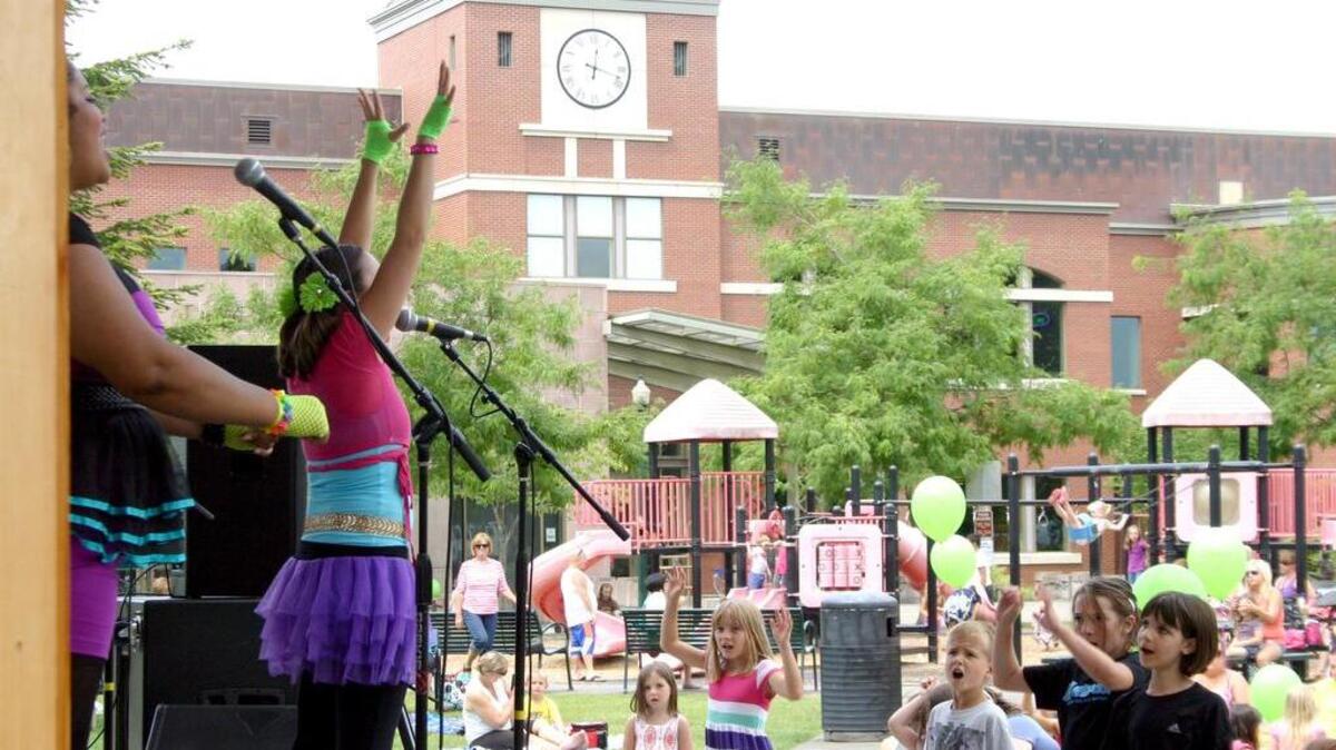 Tweenland energizes hundreds of children in Puyallup’s Pioneer Park as part of the city’s 2013 Noon Tunes concert series.