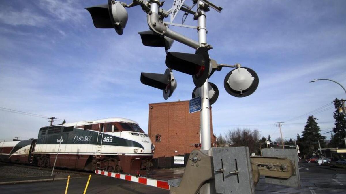 An Amtrak train moves northbound through the crossing near Pioneer Avenue and 5th Street in Puyallup last week.