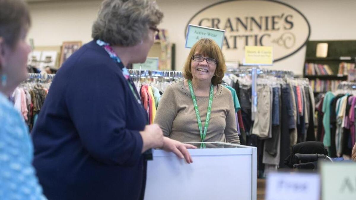 Volunteers, from left, Barb Laney, Anita Gerstmann and Georganna Megenity chat at Grannie’s Attic Thrift Shop in Puyallup on Tuesday, Jan. 9.