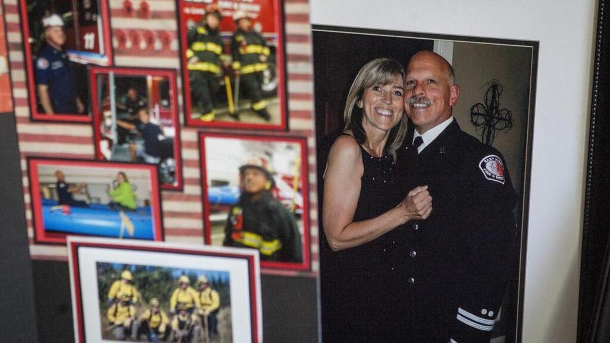 A photo of Anna and Tim McCoy is seen among several collages of photos at the McCoy home in Buckley. Tim, a 59-year-old captain with East Pierce Fire & Rescue, died from injuries sustained in a dirt bike crash last month in Bonney Lake. The posters were displayed at Tim’s memorial service on Saturday at Lighthouse Christian Center in Puyallup, where more than 700 people attended. McCoy’s reception was at Kelly Farm in Bonney Lake.