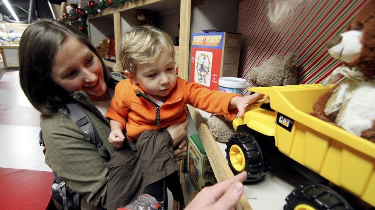 Mom Emily Roeben, of Tacoma, was at the North Pole at the Fair event Friday morning with her son Colton, 1, checking out Santa, the lights, and, of course, the toys.