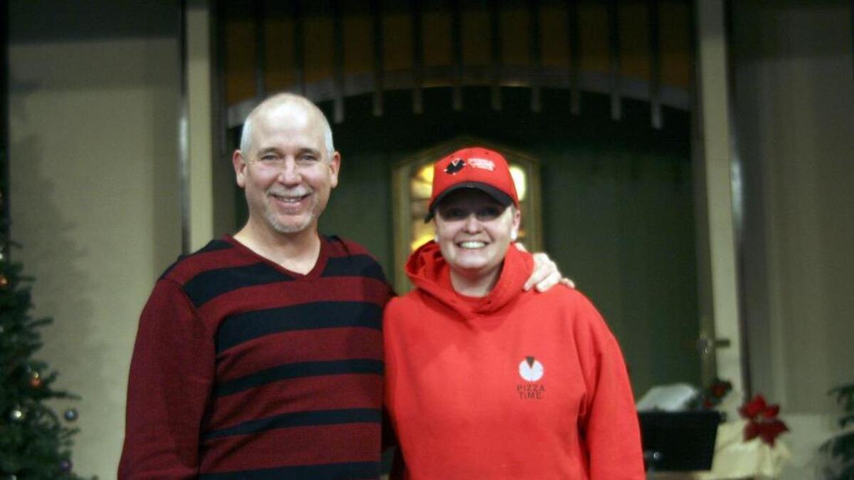 Pastor Troy Asher stands with Nicole Carroll at Cornerstone Community Church in Puyallup last week. Asher collected donations to give Carroll a nearly $1,900 tip.