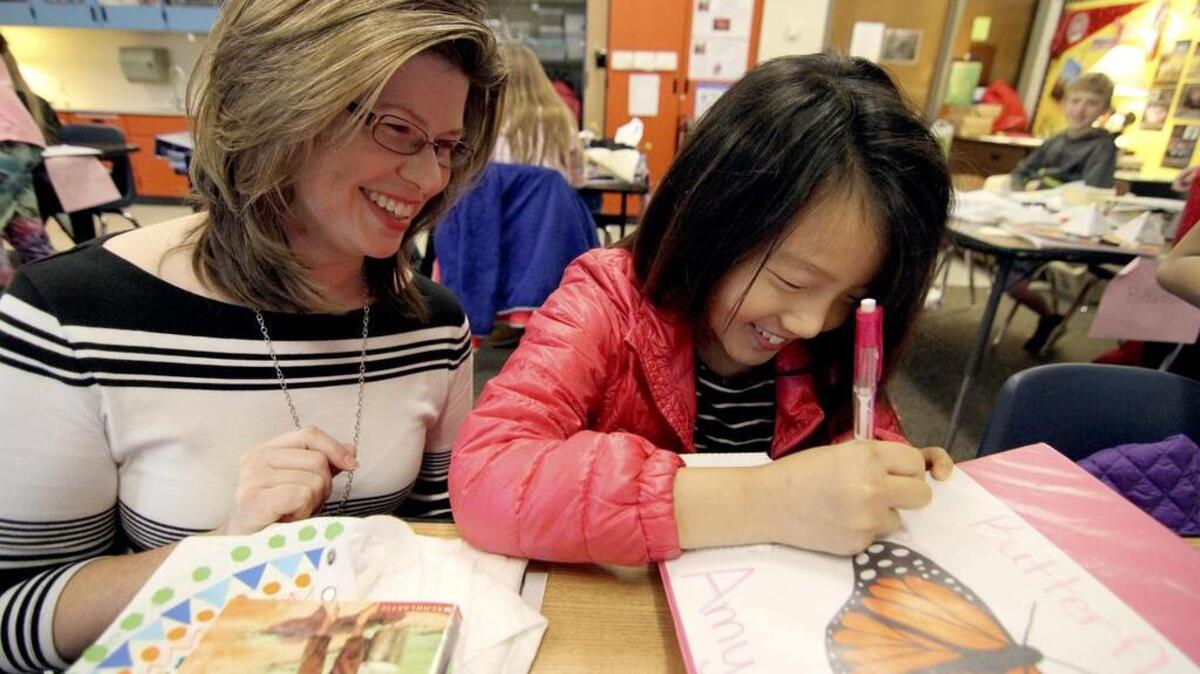 Pope Elementary School teacher Stephanie Hegel helps student Amy Lee in her combined fifth and sixth grade classroom last week. Haegele was recently named the Washington State Science Teacher of the Year.